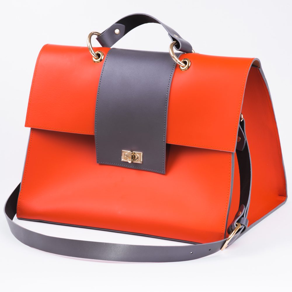 Side view of a rich coral grey structured vegan leather shoulder bag on a white background