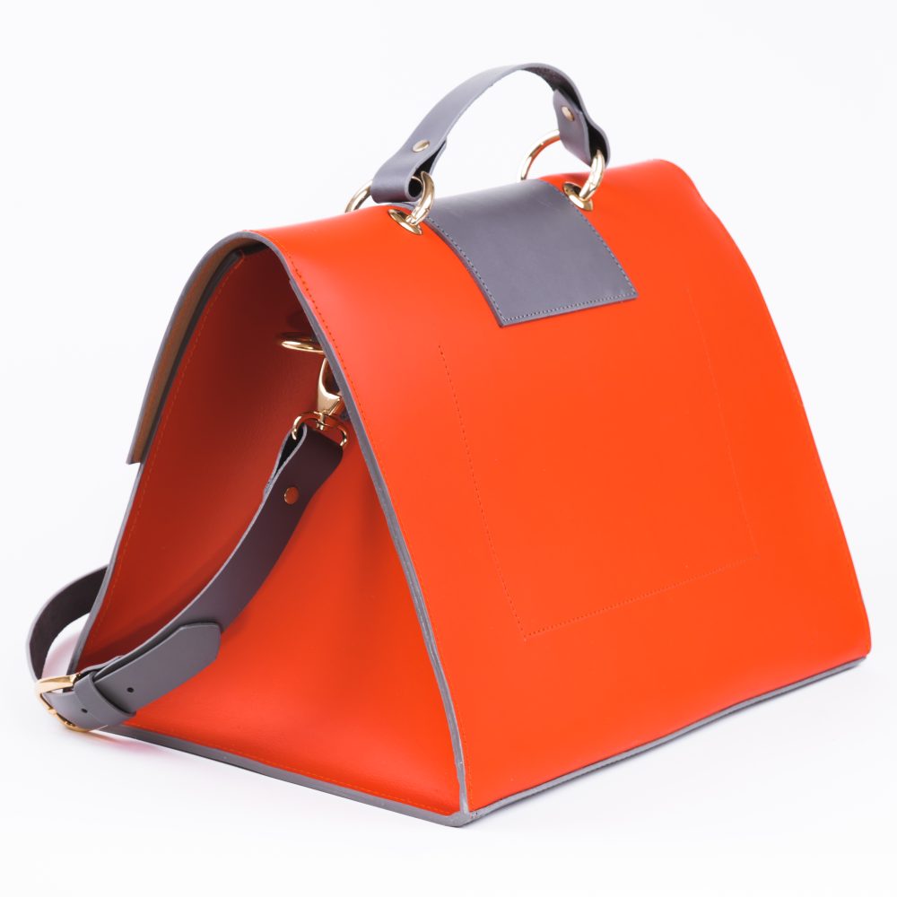 Back view of a rich coral grey structured vegan leather shoulder bag on a white background