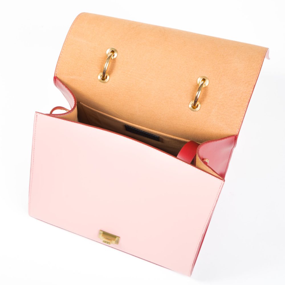 Inner view of a pink leather designer bag with a nude interior
