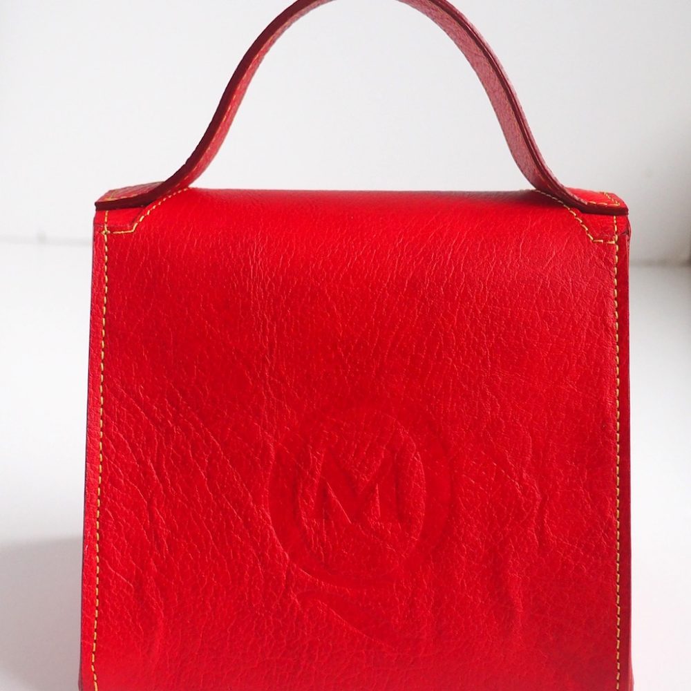Back view of a red mini designer handbag handmade in London